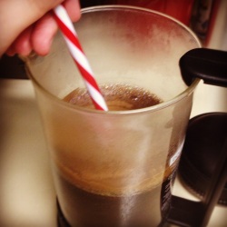 Photo of stirring coffee in a french press.